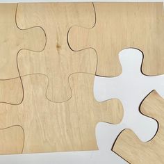 a piece of wood that has been cut out to look like a puzzle with missing pieces