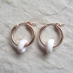 Puka Shell Hoop Earrings~ Beautiful Hawaiian puka shells adorn small tube hoops. Great gift for the beach lover! Hoops 2 X 18mm. Choose 14k gold fill, rose gold fill or sterling silver from the drop down menu. Models wearing similar designs. Shop~ http://www.etsy.com/shop/HanaMauiCreations?ref=pr_shop_more International buyers please read our shipping policies before ordering~ POLICIES~ https://www.etsy.com/shop/HanaMauiCreations/policy?ref=shopinfo_policies_leftnav Nickel-free White Small Hoop Huggie Earrings, White Nickel-free Small Hoop Huggie Earrings, Handmade White Huggie Earrings As Gift, White Nickel-free Huggie Hoop Earrings, White Hoop Huggie Earrings Gift, White Small Hoop Huggie Earrings As A Gift, White Huggie Hoop Earrings With Ear Wire, Handmade White Dainty Huggie Earrings, Handmade Dainty White Huggie Earrings