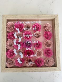 a box filled with pink paper flowers on top of a table