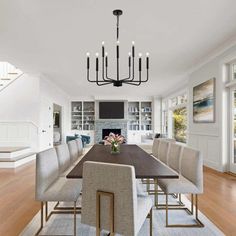 a dining room table with chairs and a chandelier