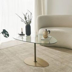 a living room with a white couch and glass table