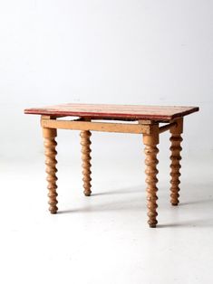 a small wooden table sitting on top of a white floor