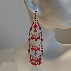 Beautiful Red Beaded Chandelier Earring. Antiqued Gold. Made In Brazil 3.5" Long Red Faceted Beads Earrings For Festive Occasions, Red Bohemian Chandelier Earrings For Pierced Ears, Red Bohemian Chandelier Earrings, Bohemian Red Chandelier Earrings, Elegant Red Chandelier Earrings With Dangling Beads, Colorful Beaded Chandelier Earrings For Party, Red Chandelier Earrings With Dangling Beads As Gift, Party Chandelier Earrings With Colorful Round Beads, Gift Red Chandelier Earrings With Dangling Beads