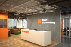 an orange and white reception desk in front of a wall with the words start co - working on it