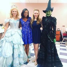 three women dressed in costume posing for a photo with one woman wearing a witch costume