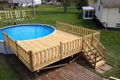 an above ground swimming pool with deck and stairs leading up to the bottom half of it