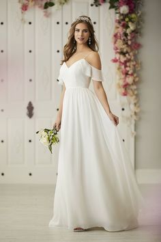 a woman in a white dress holding a bouquet