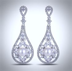 Lightweight and elegant, this beautiful pair of earrings will add glamour to any wedding dress or formal ensemble. Featuring 8mm pearls in an iridescent white color accented by sparkling cubic zirconia, the earrings are rhodium plated for a flawless finish. Overall length of the earring is 2" (approx. 5cm). Hypoallergenic - lead, nickel and cadmium free. White Cubic Zirconia Crystal Earrings With Elegant Design, Glamorous White Bridal Earrings With Diamond Accents, Pearl Bridal Earrings With Diamond Accents For Wedding, Bridal Pearl Earrings With Diamond Accents For Wedding, White Pearl Bridal Earrings With Diamond Accents, Pearl White Diamond Earrings For Wedding, White Cubic Zirconia Chandelier Earrings, Formal Diamond White Crystal Pearl Earrings, White Pearl Earrings With Diamond Accents For Wedding