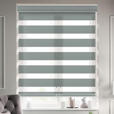 a living room with grey and white striped blinds