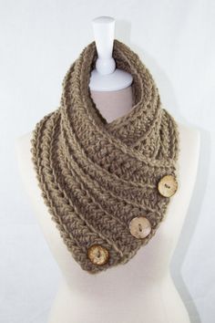 a knitted cowl with buttons on it