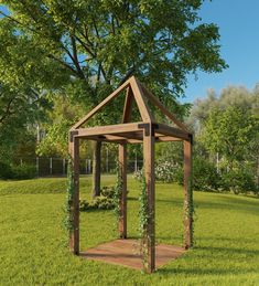 a wooden gazebo sitting on top of a lush green field