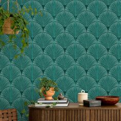 a green wallpaper with an art deco fan pattern and potted plant next to it