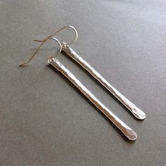 "Made to order. Please see my policies page or my shop announcement for current production times on made to order items. In case you haven't noticed yet, I'm in love with hammered stick earrings. Creating them, wearing them, staring fondly at them and whispering, \"I love you!\" when I think no one is looking. Ok, maybe not that last part. But I do love them. They're versatile, elegant, and modern - everything you could want in the perfect pair of earrings. ~ sterling silver wire and earwires ~ Hammered Minimalist Adjustable Earrings, Adjustable Hammered Minimalist Earrings, Minimalist Hammered Adjustable Earrings, Minimalist Dangle Linear Earrings As Gift, Simple Hammered Everyday Earrings, Minimalist Silver Linear Earrings For Everyday, Simple Everyday Hammered Earrings, Everyday Minimalist Silver Linear Earrings, Everyday Minimalist Handmade Earrings