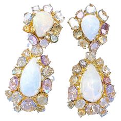 Bochic "Capri” White Opal & Multi Rose Cut Fancy Color Sapphires Earrings Set In 18K Gold & Silver Bochic Multi Gem "Capri” Earrings Natural Multi Color Sapphires - 16 Carats From Sri Lanka Fancy Rose Cut Shapes Natural White Opal - 14 Carats Pink, golden and Cream tons Cabochons Round brilliant micro pave setting Set in 22K Gold and Silver 925 The "Capri" collection features this special Earrings that are perfect for various occasions, from day to night and swimwear to evening wear. The Earrings are crafted in 18 karat gold and silver, ensuring its quality, and it bears purity marks as a testament to its authenticity. When you wear this Earrings, you are sure to steal the show and add a touch of elegance to your favorite caftan, swimsuit, or evening attire. It is designed to complement a Special Earrings, Fancy Sapphire, Pave Setting, Sapphire Earrings, Evening Attire, White Opal, Micro Pave, 22k Gold, Natural Pearls