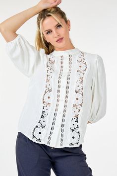 Indulge in the feminine elegance of our Women's 3/4 Lace Crochet Button Down Blouse. Crafted with delicate lace crochet, this top exudes sophistication and grace. The button-down design adds a touch of classic charm. Elevate your wardrobe with this exclusive and timeless piece. This top boasts delicate lace detailing that exudes femininity and refinement while its 3/4 sleeves strike a balance between coverage and freedom of movement. The collarless design lends a modern touch.Additionally the long popcorn sleeves add texture and visual interest elevating the tops overall appeal. - Solid - Round neckline I Collarless - Lace detailing - 3/4 Sleeve I Popcorn Spring Feminine Lace Collar Top, Feminine Lace Top For Spring, Feminine Lace Collar Blouse For Brunch, Feminine Blouse With Lace Collar For Brunch, Spring Lace Trim Button-up Top, Spring Button-up Lace Top With Lace Trim, Feminine Spring Blouse With Lace Sleeves, Feminine Lace Trim Crochet Top, Feminine Crochet Top With Lace Trim