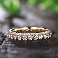 two wedding rings sitting on top of a piece of wood