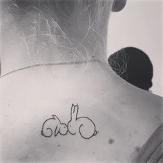 a woman with a rabbit tattoo on her back shoulder