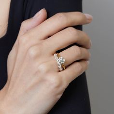 a woman's hand with a diamond ring on it