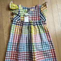 Adorable And Colorful Woven Dress Yellow Summer Play Dress, Yellow Summer Dress For Play, Playful Yellow Short Sleeve Dress, Plaid Cotton Dress For Playtime, Multicolor Cotton Dress For Playtime, Multicolor Flutter Sleeve Dress For Playtime, Cute Multicolor Flutter Sleeve Dress, Yellow Flutter Sleeve Beach Dress, Playful Yellow Cotton Dress