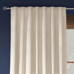 a white curtain hanging on the side of a window