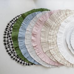 a bunch of plates that are sitting on a table together, all in different colors