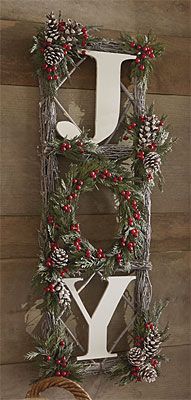 the letter y is decorated with pine cones, berries and evergreen needles for christmas decor