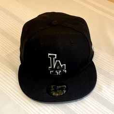 Excellent Condition New Era 59fifty Black And White La Fitted Hat. Never Been Worn, New With Tags. Is Fitted At 7 3/8, 58.7 Cm. Classic Black Baseball Cap With Flat Crown, Hip Hop Black Fitted Hat With Embroidered Logo, Classic Black Fitted Hat For Streetwear, Classic Black Fitted Hat With Embroidered Logo, Urban Black Baseball Cap With Flat Crown, Black Urban Fitted Hat For Baseball Season, Urban Black Fitted Hat For Baseball Season, Urban Black Fitted Hat With Embroidered Logo, Classic Flat Cap Fitted Hat For Streetwear