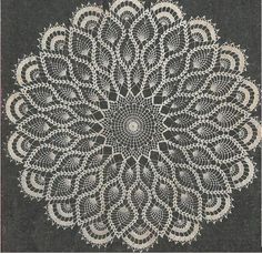 a white doily is shown on a black surface