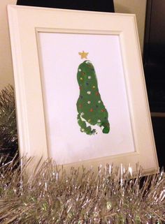 a framed christmas card with a green tree on it