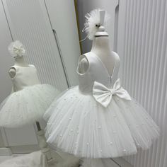 🌸 Ivory V-Back Dress, Elegant Wedding Dress, Christening Gown, Flower Girl Dress  🎀 A hair band is also sent as a gift along with this elegant dress. ✂️ Baby girl christening dress is handmade.  🌸The back of the dress consists of an open V back and a hidden zipper.  🌸The bow on the back can be removed.  🌸 The tutu tulle is fluffy to give a ballerina look.  🌸 The dress is extremely light and full.  ⭐️Our stunning knee-length flower girl dress is sure to turn heads. Your family and guests wi Cream Princess Style Sleeveless Baptism Dress, Elegant Cream Tutu Dress For Wedding, White Princess Tutu Dress For First Communion, Elegant White Princess Dress For First Communion, Cream Sleeveless Princess Dress For First Communion, Cream Sleeveless Princess Dress For Baptism, Cream Sleeveless First Communion Dress For Wedding, White Princess Tutu Dress For Confirmation, Cream Tulle Princess Dress For Baptism