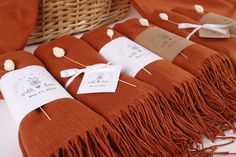 some brown blankets with tags on them sitting next to a wicker basket and other items