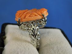 We offer free sizing, free shipping in the USA only, and a free appraisal upon request. If you are an international buyer, please contact us to work out shipping price. Also, we do not pay customs fees. Thanks. Sku: MJ1018 This is a 11.25 ct. Hand-Carved Pink Coral gemstone ring. This is a natural floral Coral in a sterling silver .925 setting. The ring was made in the USA by our staff gemologist and jeweler. Every ring is unique and one of a kind. The beautiful Coral is 14 mm x 22 mm. The total Coral Gemstone, Floral Ring, Ring Art Deco, Sterling Silver Filigree, Pink Coral, Silver Filigree, Art Deco Style, Deco Style, Solitaire Ring