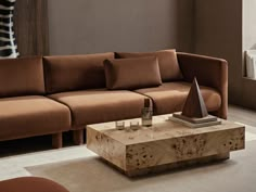 a living room with a brown couch and coffee table