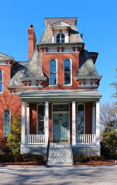 a large red brick house with white trim