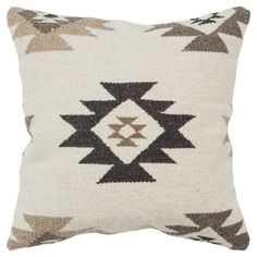 a brown and white pillow with an arrow design on the front, sitting on a white background