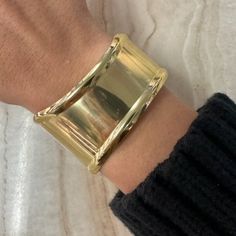 Gold-plated over brass. Adjustable statement cuff. Classic Gold-tone Metal Cuff Bracelet, Elegant Open Cuff Metal Bracelet, Gold Polished Cuff Bracelet, Classic Brass Cuff Bracelet For Formal Occasions, Formal Polished Brass Cuff Bracelet, Elegant Bronze Metal Cuff Bracelet, Chic Formal Gold-tone Cuff Bracelet, Chic Formal Metal Cuff Bracelet, Gold Brass Cuff Bracelet With Wide Band