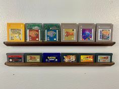 several nintendo games are displayed on wooden shelves