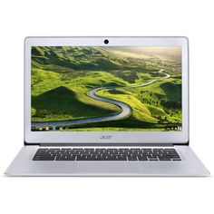 an open laptop computer sitting on top of a white table next to a green field