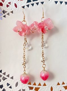 pink Sakura Flower Earrings The pink sakura flower earrings feature there glazed sakura and one plastic flower drop. They are really comfortable for everyday wear.  Available in GOLD and Silver finish! M A T E R I A L S * A N D * S I Z E  The hook is 14K gold filled - Length: 80mm(without the hook) - Width: 23mm Pink Whimsical Flower Charm Earrings, Pink Whimsical Flower Earrings With Flower Charm, Pink Flower Crystal Earrings, Whimsical Pink Earrings With Flower Charm, Whimsical Pink Flower Charm Earrings, Pink Whimsical Flower Earrings For Pierced Ears, Whimsical Pink Flower Earrings For Pierced Ears, Rose Gold Flower-shaped Jewelry For Summer, Whimsical Pink Dangle Flower Earrings