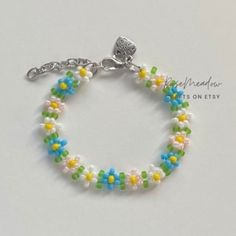 "Handmade Beaded Bracelet  ✿ Made with glass seed beads and metal accents ✿ Sky blue, yellow, milky white, light pink, and matte lime green ✿ The bracelet has 1.5\" of extension chain" Handmade Beaded Bracelets For Friendship In Spring, Handmade Beaded Bracelets For Spring, Handmade Multicolor Beaded Bracelets For Spring, White Spring Jewelry For Friendship, Handmade Blue Friendship Bracelets For Spring, White Round Beaded Friendship Bracelets For Spring, Spring Blue Beaded Bracelets, White Spring Jewelry With Tiny Beads, Spring White Jewelry With Tiny Beads