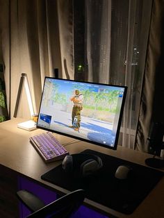 a computer monitor sitting on top of a wooden desk next to a keyboard and mouse