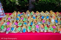 a table topped with lots of candy bags covered in colorful writing on it's sides