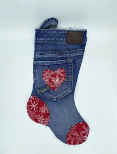 a pair of blue jeans with red hearts in the back pocket on a white background