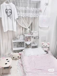 a white bedroom with pink bedding and teddy bears