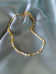 Handmade yellow beaded necklace! The whole length of the necklace (including extension) is approximately 45cm. If you have any questions, please message me! Yellow Necklace Bead, Yellow Bead Necklace, Trendy Yellow Necklace With Tiny Beads, Yellow Choker Necklace As A Gift, Yellow Choker Necklace For Gift, Yellow Beaded Necklaces With Letter Beads For Summer, Trendy Yellow Beaded Necklaces With Round Beads, Yellow Round Bead Necklaces For Summer, Yellow Necklaces With Colorful Beads For Summer