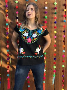 Beautiful Embroidered Floral Blouse From Chiapas. This blouse is hand embroidered and made with love by Mexican Artisans. It is the perfect pop of color to add style to your wardrobe. Note: You have the option to purchase the blouse with the belt modeled for a special price or purchase the blouse without the belt, Festival Embroidered Multicolor Top, Folk Style Floral Embroidered Top For Festive Occasions, Bohemian Tops With Multicolor Resham Embroidery, Festive Folk Style Embroidered Top With Floral Embroidery, Multicolor Embroidered Blouse For Fiesta Festivals, Black Floral Embroidered Tops For Festivals, Multicolor Embroidered Folk Top With Embroidered Border, Black Tops With Floral Embroidery For Festivals, Festive Traditional Top With Floral Embroidery