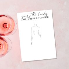 three wine glasses and a paper with a drawing of a woman's torso