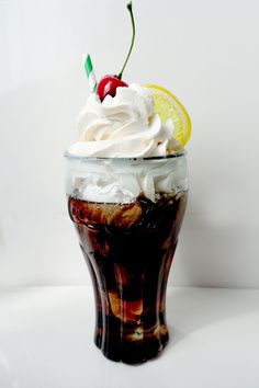 there is a drink with whipped cream and a cherry on top