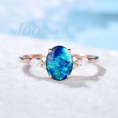 1.5ct Natural Blue Opal Engagement Ring Vintage Rose Gold Wedding Ring Unique Anniversary Gift Galaxy Blue Fire Opal Moissanite Promise Ring 30 days non-hassle return policy. For returned items, there may be handcrafting and shipping fee deducted.  DETAILS: - Material : 925 Sterling Silver (Hypoallergenic, Nickel Free, Tarnish Resistant)Solid 14k/18k gold,platinum PLEASE choose silver or platinum if you are allergic to nickel. - Main stone : 6*8mm Oval cut 1.5ct blue opal - Accent Stone : Simulated Diamonds - Stone Cut : Oval  ACCEPT CUSTOM SERVICE: 1. Accept engrave the words inside the ring.  2. Accept change main stone type, size : 6*8 mm 3. Accept change other material : This jewelry can also be made in solid gold (including 10/14/18k white/rose/yellow gold...), platinum Please contact Blue Opal Ring Engagement, Sapphire Opal Engagement Ring, Blue Opal Rings, Blue Opal Engagement Ring, Blue Stone Engagement Ring, Vintage Rose Gold Wedding Ring, Vintage Wedding Rings Rose Gold, Opal Engagement Ring Vintage, Engagement Ring Blue Stone