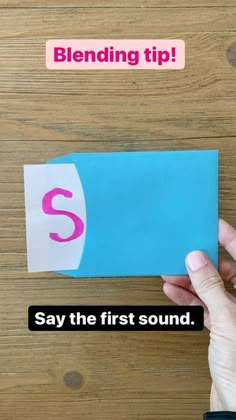 someone holding up a piece of paper with the letter s on it that says, blending tip say the first sound